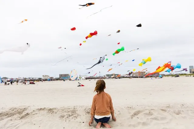 Riley Gimenez, 6, watches kites on the beach during the Memorial Day weekend on May 28, 2023 in Wildwood, New Jersey. Memorial Day weekend kicks off the start of the beach season on the East Coast. (Photo by Hannah Beier/Getty Images)