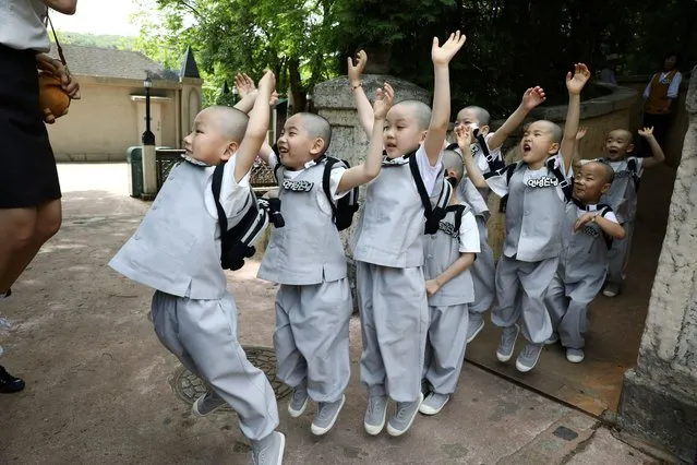 Boys who are experiencing the lives of Buddhist monks by staying in a temple for three weeks as novice monks, play at Everland amusement park in Yongin, South Korea on May 17, 2023. (Photo by Kim Soo-hyeon/Reuters)