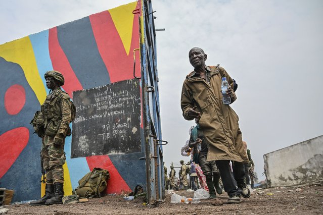 Government soldiers and police officers, right, who surrendered to M23 rebels, left, board trucks to an undisclosed location in Goma, Democratic republic of the Congo, Thursday, January 30, 2025. (Photo by Moses Sawasawa/AP Photo)