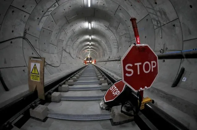 Warning signs stand on newly laid railway track in a tunnel of the Crossrail project in Stepney, east London, Britain, November 16, 2016. (Photo by Stefan Wermuth/Reuters)