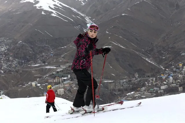 In this Friday, January 16, 2015 photo, Iranian skier Zahra Jabbari stands prior to her descent from a slope at the Shemshak ski resort in the Alborz mountain range 36 miles (60 kilometers) northeast of the capital Tehran, Iran. With quite steep slopes at an altitude of 2550m to 3050m above sea level, lighting facilities for night skiing, and a normal ski season from late November to late April, Shemshak attracts many advanced Iranian and foreign skiers. (Photo by Vahid Salemi/AP Photo)
