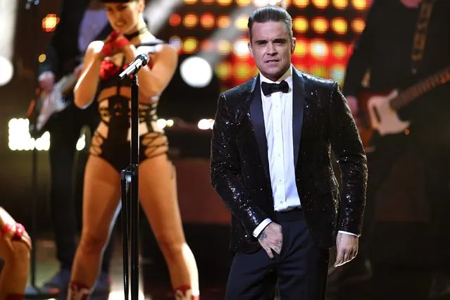 Robbie Williams grabs into his trousers as he performs on stage during the Bambi Awards 2016 show at Stage Theater on November 17, 2016 in Berlin, Germany. (Photo by Alexander Koerner/Getty Images)