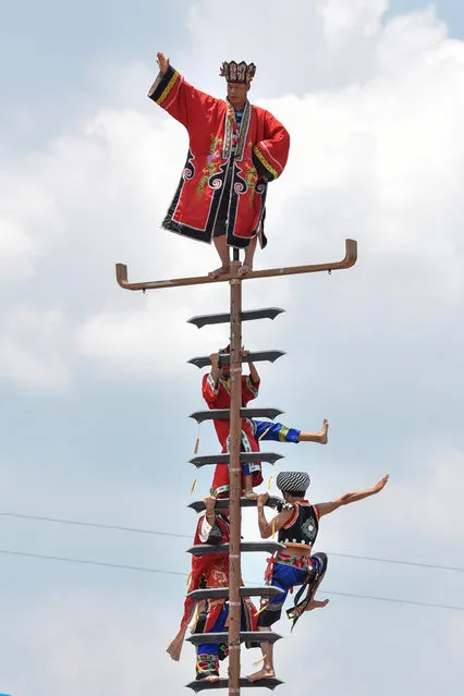 People of Miao ethnic minority climb a blade ladder to celebrate the traditional festival on the 6th day of the 6th month of the Chinese traditional lunar calendar at Songtao Miao Autonomous County on July 18, 2018 in Tongren, Guizhou Province of China. (Photo by VCG)
