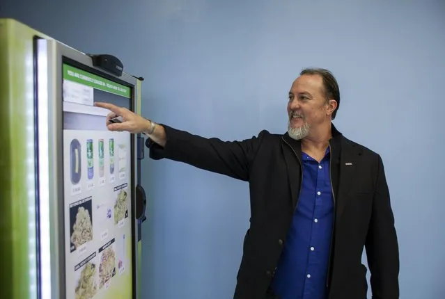 Stephen Shearin demonstrates the use of a ZaZZZ vending machine that contains cannabis flower, hemp-oil energy drinks, and other merchandise at Seattle Caregivers, a medical marijuana dispensary, in Seattle, Washington February 3, 2015. (Photo by David Ryder/Reuters)