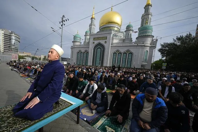 Muslims pray outside the Moscow Cathedral Mosque during celebrations in Moscow, Russia, on Wednesday, June 28, 2023. Around the world, Muslims will mark the end of the pilgrimage with Eid al-Adha. The holiday commemorates the prophet Ibrahim's willingness to sacrifice his son Ismail at God's request. Muslims traditionally slaughter sheep and cattle, dividing the meat among the needy, friends and relatives. (Photo by Alexander Zemlianichenko/AP Photo)