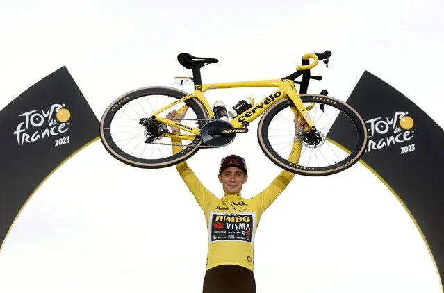 Jonas Vingegaard of Denmark and Team Jumbo-Visma - Yellow Leader Jersey celebrates at podium as final overall winner with a custom yellow Cervélo bike during the stage twenty-one of the 110th Tour de France 2023 a 11 5.1km stage from Saint-Quentin-en-Yvelines to Paris / #UCIWT / on July 23, 2023 in Paris, France. (Photo by Benoit Tessier/Reuters)