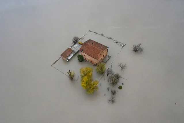 In an aerial view from a drone, buildings are seen submerged by flood waters from the Panaro River, affecting dozens of inhabited houses and some farms on December 06, 2020 in Modena, Italy. (Photo by Michele Lapini/Getty Images)