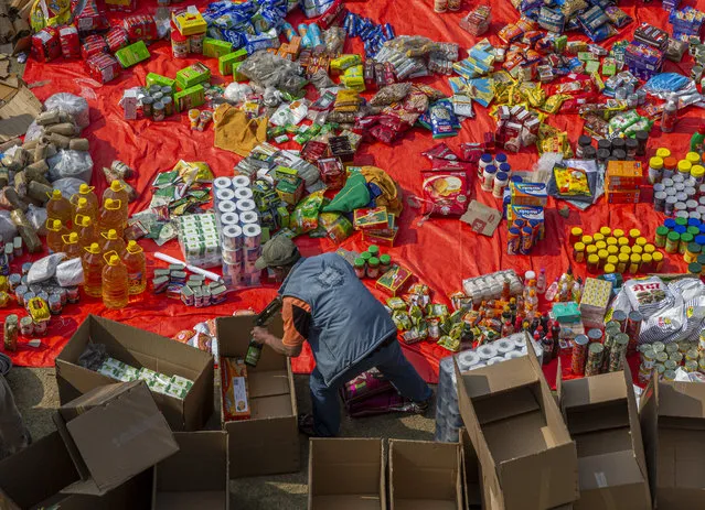 Workers sift through supplies at seven summit trek in Kathmandu, Nepal, 15 March 2021. Record holder Nepalese mountaineer Kami Rita Sherpa is attempting to break his own World Record of climbing Everest this spring season for the 25th time. More than 300 hundred foreign climbers are likely to attempt to make the summit of Mt. Everest, 8,848.86 meters,  an expedition which will is scheduled to begin from April 2021 for this year, said official from the Nepal Tourism Department. (Photo by Narendra Shrestha/EPA/EFE)