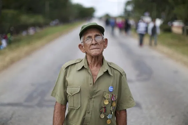 Revolutionary Esteban Leiva, 84, who fought with Raul Castro in Sierra Maestra, awaits the arrival of the caravan carrying the late Cuban leader's ashes in Gaspar, Cuba, December 1, 2016. (Photo by Alexandre Meneghini/Reuters)