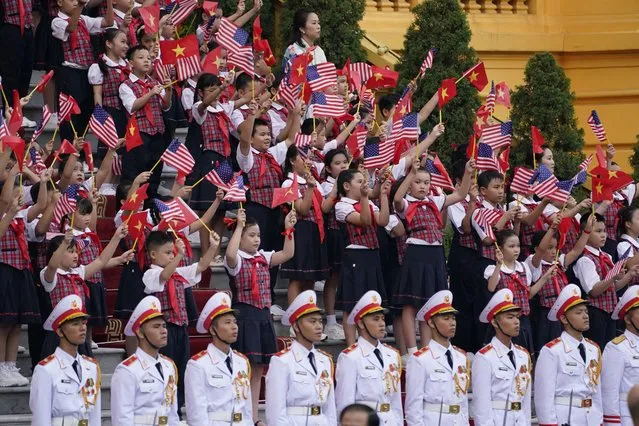 Children wave flags of both countries as U.S. President Joe Biden participates in a welcome ceremony hosted by Vietnam's Communist Party General Secretary Nguyen Phu Trong at the Presidential Palace in Hanoi, Vietnam, Sunday, September 10, 2023. (Photo by Evan Vucci/AP Photo)