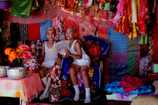 Danusorn Sdisaithaworn (L), 10, and Gorsak Kong Tawan, 13, rest at an altar made for them at their home after an annual Poy Sang Long procession, part of the traditional rite of passage for boys to be initiated as Buddhist novices, in Mae Hong Son, Thailand April 3, 2018. (Photo by Jorge Silva/Reuters)