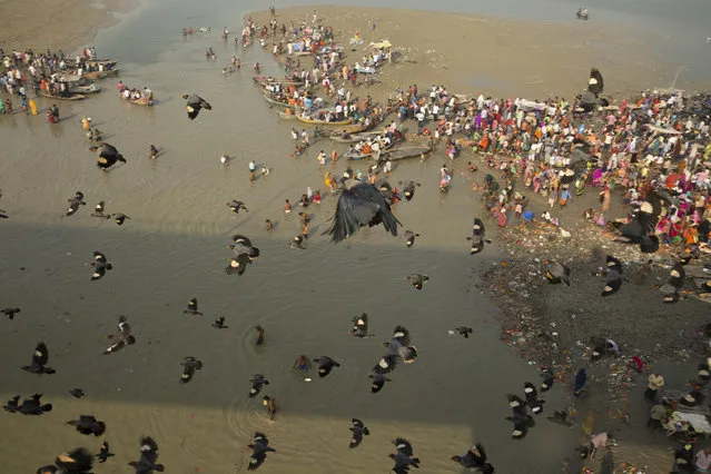 Indian Hindu devotees perform morning rituals in the Ganges River on the first day of the nine-day Navratri festival in Allahabad, India, Wednesday, October 10, 2018. Hindus are celebrating Navaratri, or the festival of nine nights, with three days each devoted to the worship of Durga, the goddess of valor, Lakshmi, the goddess of wealth, and Saraswati, the goddess of knowledge. (Photo by Rajesh Kumar Singh/AP Photo)