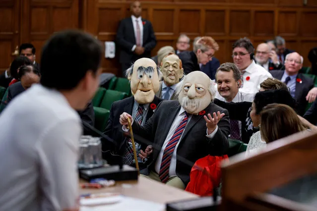 Canada's Prime Minister Justin Trudeau is met with people wearing the face masks of Muppets characters Waldorf and Statler during a caucus meeting on Hallowe'en Day in Ottawa, Ontario, Canada, October 31, 2018. (Photo by Adam Scotti/Prime Minister's Office/Handout via Reuters)