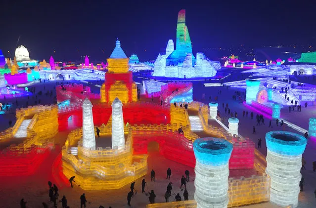 An aerial view shows people touring between the large-scale ice sculptures at the 18th Harbin Ice and Snow World during its trial run opening to public in Harbin city, Heilongjiang province, China, 21 December 2016. Some 180,000 cubic meters of ice and 150,000 cubic meters of snow were used to build the 800,000-square-meter ice wonderland. The 33rd Harbin International Ice and Snow Festival will kick off on 05 January 2017 that will last about three months. (Photo by Tian Weitao/EPA)