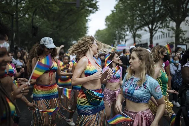 Participants dance, during the annual Gay Pride march in Paris, Saturday, June 26, 2021. (Photo by Lewis Joly/AP Photo)