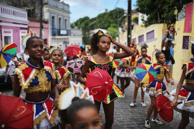 Revellers parade during pre-Carnival celebrations on January 30, 2016 in Recife, Pernambuco state, Brazil. Health officials believe as many as 100,000 people have been exposed to the Zika virus in Recife, although most never develop symptoms. Carnival celebrations are continuing normally as planned. In the last four months, authorities have recorded around 4,000 cases in Brazil in which the mosquito-borne Zika virus may have led to microcephaly in infants. (Photo by Mario Tama/Getty Images)
