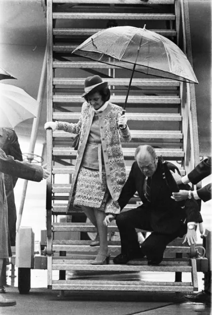 In this June 1, 1975 picture, President Gerald Ford lands on his hands after slipping and falling on a wet ramp, while disembarking from Air Force One in Salzburg, Austria. A military aide, grabs the president to help break the fall. The president's wife, Betty, is at left. (Photo by Peter Bregg/AP Photo)