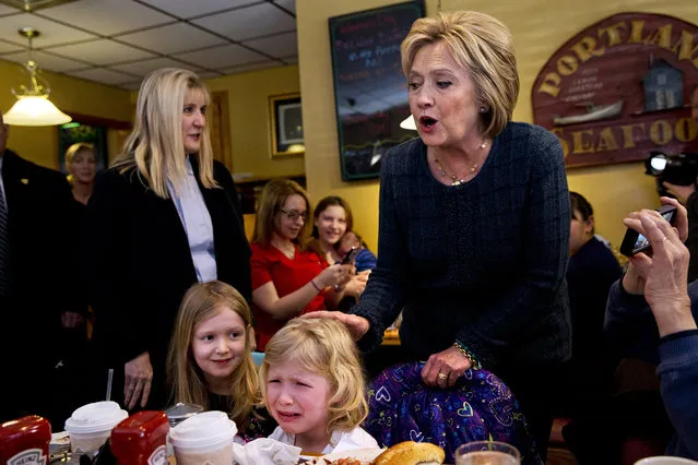 Ella Hamel, 4, of Concord, N.H., cries as she and her sister Ava Hamel, 7, are greeted by Democratic presidential candidate Hillary Clinton during a campaign stop at Belmont Hall in Manchester, N.H., Friday Saturday, February 6, 2016. Her father Steve Hamel says that Ella likes Clinton, supporting her in activities at her school, and was likely feeling “a little overwhelmed”. (Photo by Jacquelyn Martin/AP Photo)