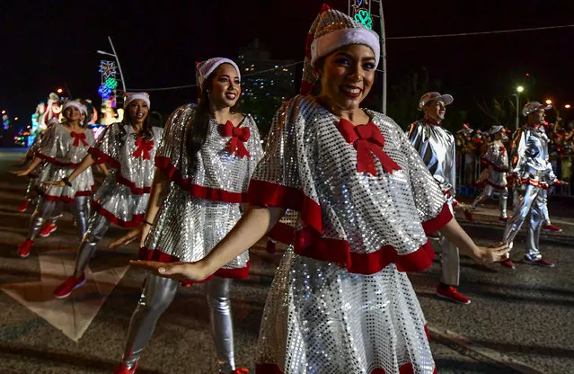 Revelers and musicians perform during the Christmas parade in Panama City on December 16, 2018. (Photo by Luis Acosta/AFP Photo)