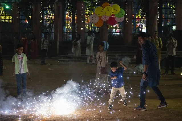 People light fire crackers during festival of lights Diwali in Mumbai, India, Sunday, November 12, 2023. (Photo by Rafiq Maqbool/AP Photo)