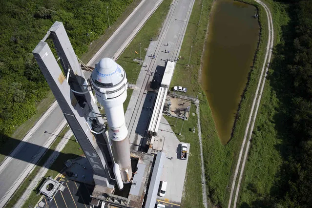 In this image provided by NASA, a United Launch Alliance Atlas V rocket with Boeing's CST-100 Starliner spacecraft onboard is rolled out of the Vertical Integration Facility to the launch pad at Space Launch Complex 41, Thursday, July 29, 2021 at Cape Canaveral, Fla. in Florida. Boeing's Orbital Flight Test-2, scheduled for early Friday, July 30,  will be Starliner's second uncrewed flight test and will dock to the International Space Station as part of NASA's Commercial Crew Program. (Photo by Joel Kowsky/NASA via AP Photo)