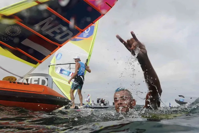 Kiran Badloe, from The Netherlands, celebrates after placing first in the men's windsurfer medal race at the 2020 Summer Olympics, Saturday, July 31, 2021, in Fujisawa, Japan. (Photo by Gregorio Borgia/AP Photo)