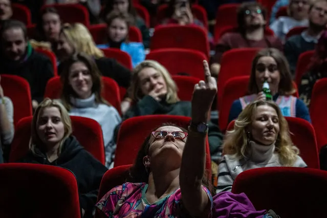 A woman reacts as she watches in a cinema a parliament session on a confidence vote of outgoing Polish prime minister Mateusz Morawiecki in Warsaw, December 11, 2023. Polish lawmakers voted to reject the proposed conservative government, a widely expected outcome that paves the way for the rival pro-EU alliance to form the next administration. (Photo by Wojtek Radwanski/AFP Photo)