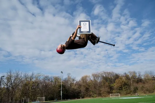 Henry Cabelus, from U.S., who achieves the highest backflip pogo stick jump is 3.07 m (10 ft 1 in), performs in Pittsburgh, Pennsylvania, U.S. November 4, 2023 in celebration of Guinness World Records Day 2023. (Photo by Guinness World Records Day 2023/Handout via Reuters)