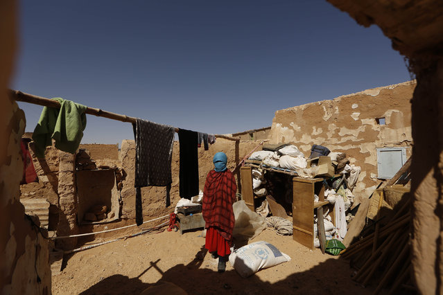 An indigenous Sahrawi woman stands inside her shelter, which was damaged by flood last October, in a refugee camp of Boudjdour in Tindouf, southern Algeria March 3, 2016. UN Secretary General Ban Ki-moon is scheduled to visit the Sahrawi refugees in south-west Algeria's Tindouf region. (Photo by Zohra Bensemra/Reuters)