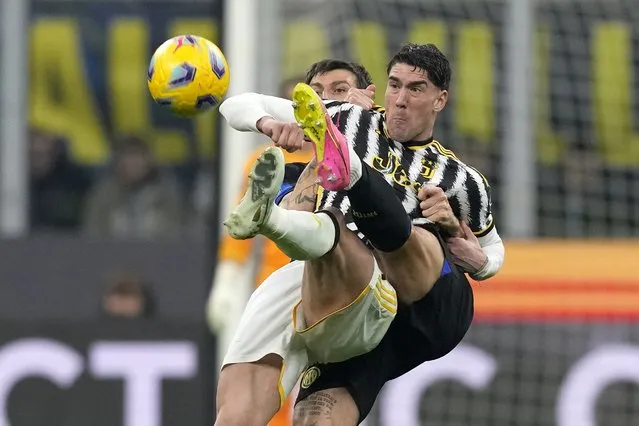 Inter Milan's Francesco Acerbi, left, and Juventus' Dusan Vlahovic fight for the ball during a Serie A soccer match between Inter Milan and Juventus, in Milan, Italy, Sunday, February 4, 2024. (Photo by Antonio Calanni/AP Photo)