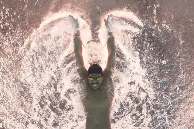 Al Kulaibi Mskm of Oman competes in the men's 100-meter butterfly heat at the World Aquatics Championships in Doha, Qatar, Friday, February 16, 2024. (Photo by Lee Jin-man/AP Photo)