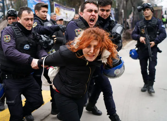 Riot police detain a demonstrator during a protest against the dismissal of academics from universities following a post-coup emergency decree, outside the Cebeci campus of Ankara University in Ankara, Turkey, February 10, 2017. (Photo by Umit Bektas/Reuters)