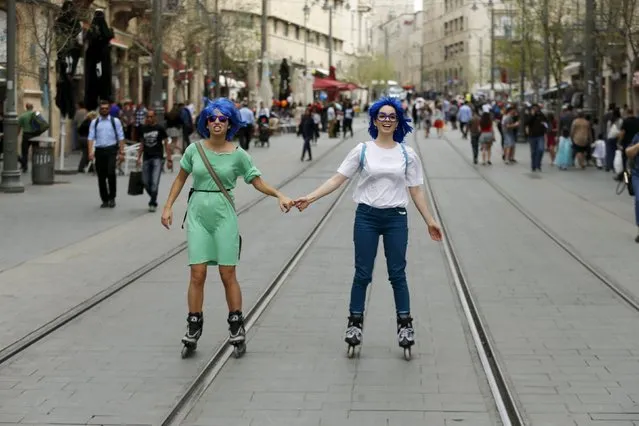 Women wear wigs and roller blades as they mark the Jewish holiday of Purim in Jerusalem March 24, 2016. (Photo by Ammar Awad/Reuters)