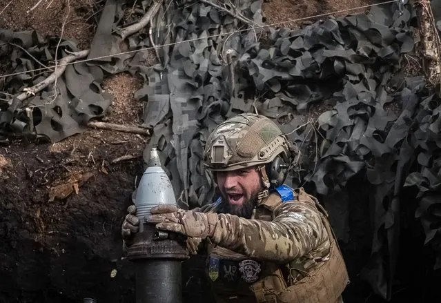 A Ukrainian serviceman of the 28th Separate Mechanized Brigade fires a 120-mm mortar towards Russian troops at the frontline, near the town of Bakhmut, Ukraine, on March 5, 2024. (Photo by Inna Varenytsia/Reuters)