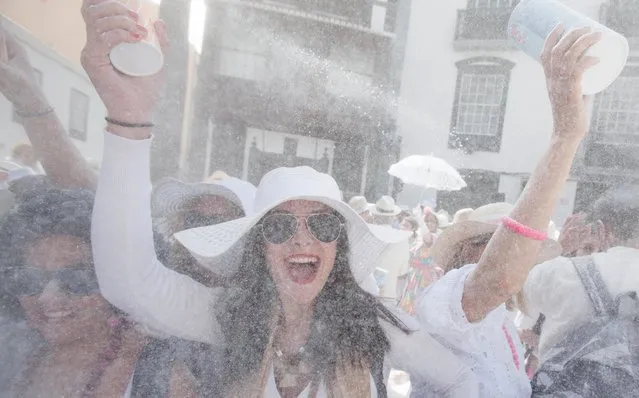People throw talcum powder as they take part in the carnival of “Los Indianos” (the Indians) in Santa Cruz de la Palma, on the Spanish Canary island of Las Palma on March 3, 2014. (Photo by Desiree Martin/AFP Photo)