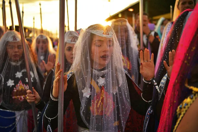 Nymphs, female devotees of the Vale do Amanhecer religious community, pray during their biggest ceremony of the year at their temple complex in Vale do Amanhecer (Sunrise Valley), a community on the outskirts of Planaltina, 50 km from the Brazilian capital, Brasilia, on May 1, 2019. This eclectic community holds its most important ritual of the year on Labour Day to honour the mediums who communicate with good and bad spirits. The group combines a range of religious practices, including Christian and Hindu, with symbols borrowed from the Incas and Mayans, as well as a belief in extraterrestrial life and intergalactic travel. With some 600 temples throughout Brazil, Portugal, Germany, Japan, Bolivia, Uruguay and the United States, the religious movement claims to have 800,000 members. (Photo by Carl De Souza/AFP Photo)