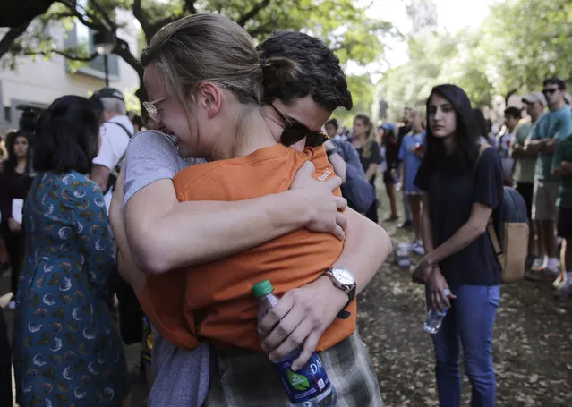 University of Texas students embrace during a gathering for fellow student Haruka Weiser on campus, Thursday, April 7, 2016, in Austin, Texas. Weiser, a first-year theater and dance student from Oregon, was found dead on campus after she was reporter missing earlier this week. (Photo by Eric Gay/AP Photo)