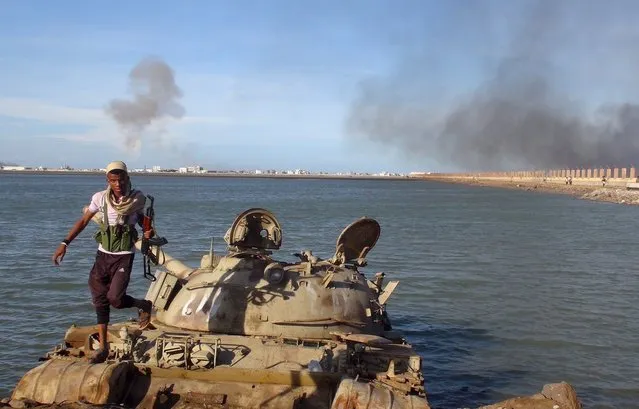 A Southern Popular Resistance fighter walks on a tank in Yemen's southern city of Aden May 3, 2015. (Photo by Reuters/Stringer)