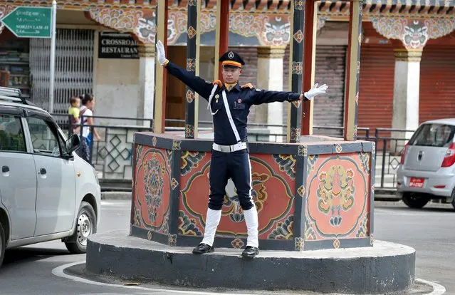 A policeman directs traffic in Thimphu, Bhutan, April 18, 2016. (Photo by Cathal McNaughton/Reuters)
