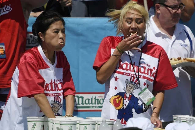 Juliet Lee, left, and Miki Sudo, right, compete in the women's competition of Nathan's Famous July Fourth hot dog eating contest, Thursday, July 4, 2019, in New York's Coney Island. (Photo by Sarah Stier/AP Photo)