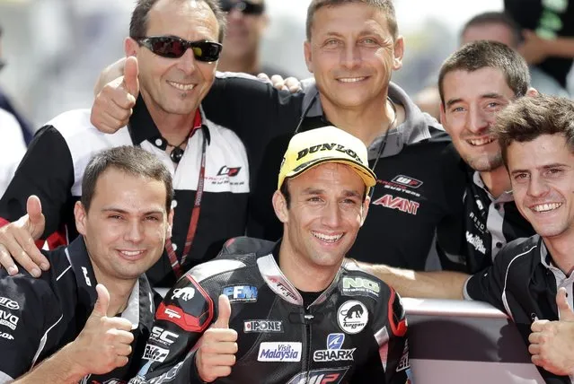 Moto2 rider Johann Zarco of France reacts after clocking the fastest time to take pole position for Sunday's Spanish Motorcycling near of second fastest time Spain's Maverick Vinales, center right, in Montmelo, Spain, Saturday, June 13, 2015. The Catalunya Grand Prix will take place on Sunday in Montmelo. (AP Photo/Manu Fernandez)