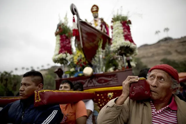 Fishermen carry a statue of Saint Peter during a procession in Lima, Peru, Monday, June 29, 2015. (Photo by Rodrigo Abd/AP Photo)