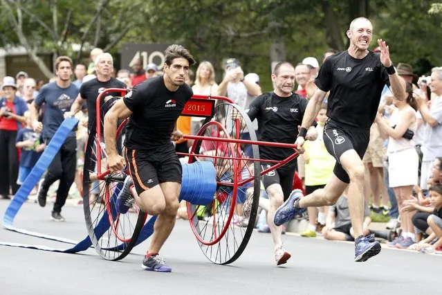 Members of a Belgian team from Brussels sprint with a fire hose during the hose cart competition of the Firefighter Muster event at the World Fire and Police Games in Fairfax, Virginia July 4, 2015. Organizers said thousands of police and firefighter athletes from about 70 countries competed in traditional sports as well as events meant to show their skill as first responders during the 10-day meet. (Photo by Jonathan Ernst/Reuters)