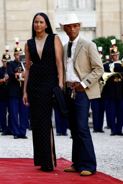 American rapper Pharrell Williams and a guest arrive to attend a state dinner in honor of U.S. President Joe Biden and first lady Jill Biden at the Elysee Palace in Paris, France on June 8, 2024. (Photo by Sarah Meyssonnier/Reuters)