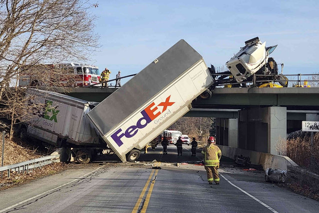 Firefighters from the West Henrietta Fire Department investigate the scene of a crash where a tandem tractor trailer overturned on a bridge on eastbound Interstate 90, Thursday, March 14, 2024 in Pittsford, N.Y. (Photo by Henrietta Fire District via AP Photo)