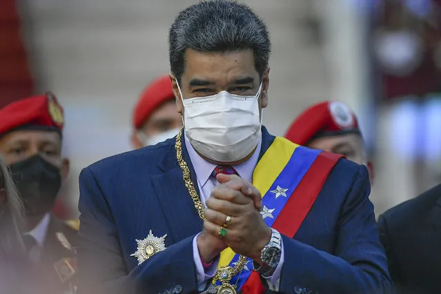 Venezuela's President Nicolas Maduro clasps his hands as he arrives to deliver his State of the Nation address at the National Assembly in Caracas, Venezuela, Saturday, January 15, 2022. (Photo by Matias Delacroix/AP Photo)