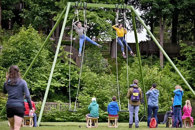 Daunta Ramos and Beverley Grant, from All or Nothing Aerial Dance Theatre, one of the UK's leading aerial dance companies, perform at Dalkieth Country Park as they announce the Scottish tour on July 06, 2021 in Dalkeith, Scotland. Edinburgh's All or Nothing Aerial Dance Theatre is touring this interactive production, staged on a larger-than-life swing set, which also invites the audience to sit on swings and listen to a soundtrack evocative of childhood swinging. (Photo by Jeff J. Mitchell/Getty Images)