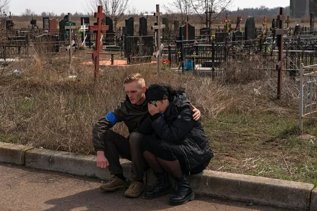 Family of one of the five Ukrainian soldiers embrace following a military funeral service in Odessa, Ukraine, Tuesday, March 29, 2022. Four of the soldiers were killed on March 18th during a Russian airstrike that hit the 36th Ukrainian Naval Infantry Brigade killing more than 40 Ukrainian soldiers in the city of Mykolaiv. (Photo by Salwan Georges/The Washington Post)