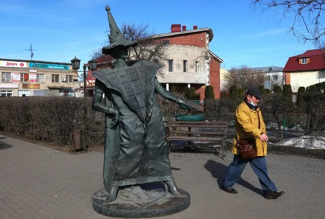 A man walks past the statue “Chocolate fairy” in the town of Pokrov in Vladimir Region, Russia March 21, 2022. (Photo by Evgenia Novozhenina/Reuters)
