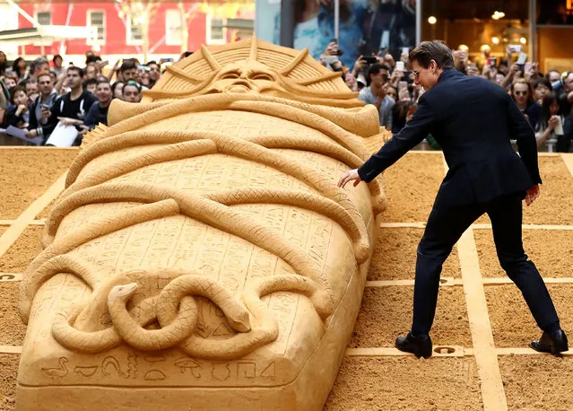 Tom Cruise touches the Mummy sand sculpture during a photo call for “The Mummy” at World Square on May 23, 2017 in Sydney, Australia. (Photo by Ryan Pierse/Getty Images)
